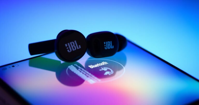 A close-up of sleek, modern JBL earbuds resting on a vibrant, glowing smartphone screen with a digital interface displaying a Bluetooth connection process. The background is a gradient of blue and green, suggesting technology and innovation, while soft light highlights the earbuds' design, emphasizing their compact form and stylish aesthetics.